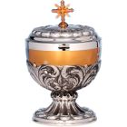 Silver ciborium with relief decoration and golden fringe