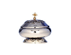 Smooth silver ciborium with liturgical elements in relief