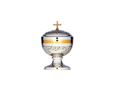Chiselled silver ciborium with Cross and golden details