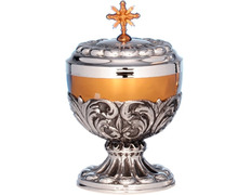 Silver ciborium with relief decoration and golden fringe