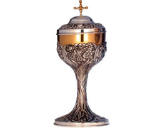 Silver ciborium with chiselled liturgical elements