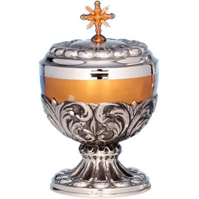 Silver ciborium with relief decoration and golden fringe