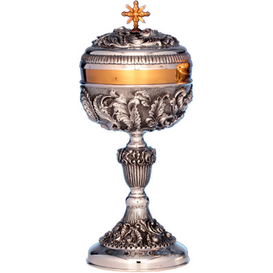 Silver ciborium with liturgical elements in relief