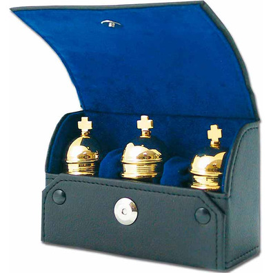 Three gold plated crismeras with case