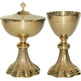 Golden metal chalice with grapes and spikes